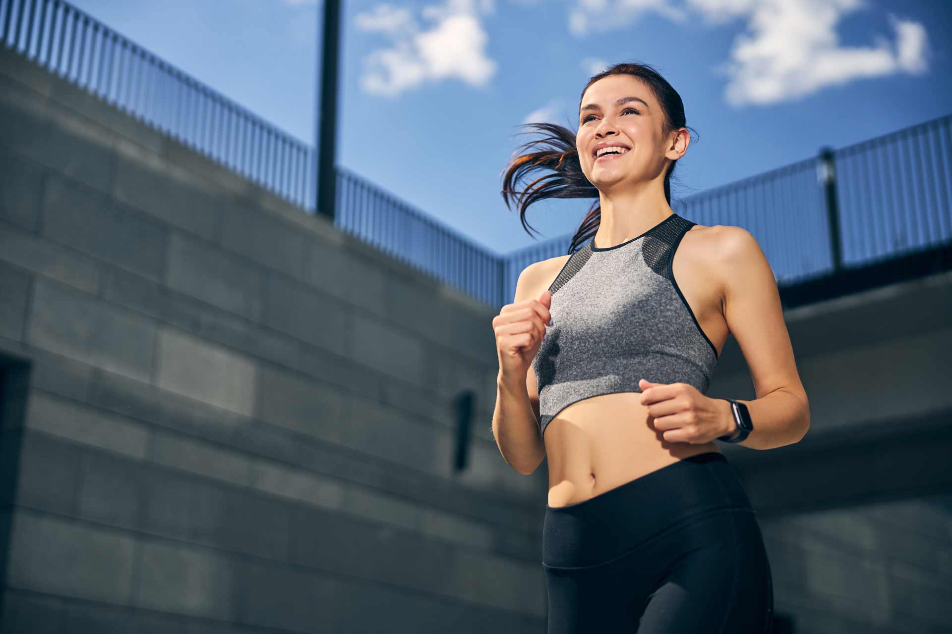 Positive delighted young woman running with pleasure